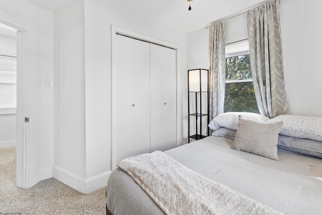 carpeted bedroom featuring a closet