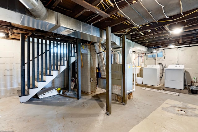 basement with heating unit and washing machine and clothes dryer