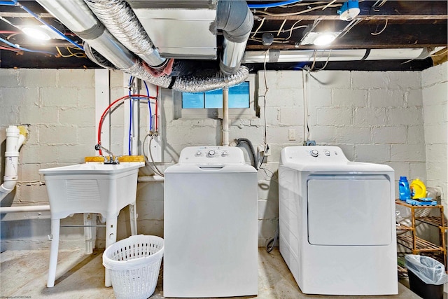 laundry area featuring sink and washing machine and dryer