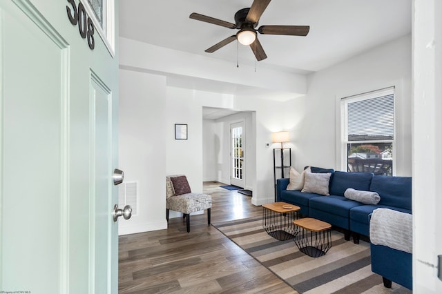 living room with dark hardwood / wood-style floors and ceiling fan