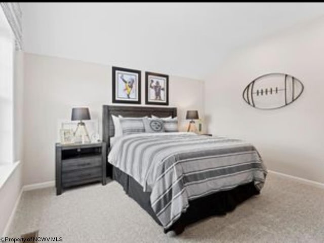 carpeted bedroom with vaulted ceiling