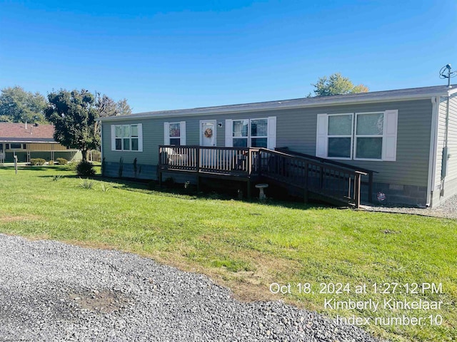 manufactured / mobile home with a front yard and a deck