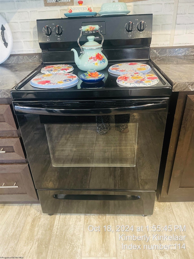 interior details with dark brown cabinets and black range with electric cooktop