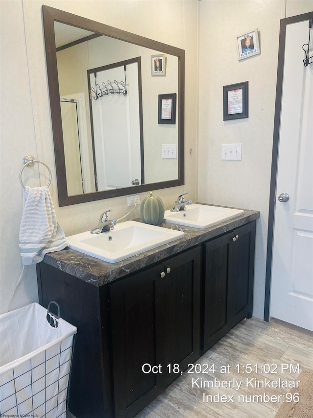 bathroom with wood-type flooring, vanity, and a bathing tub