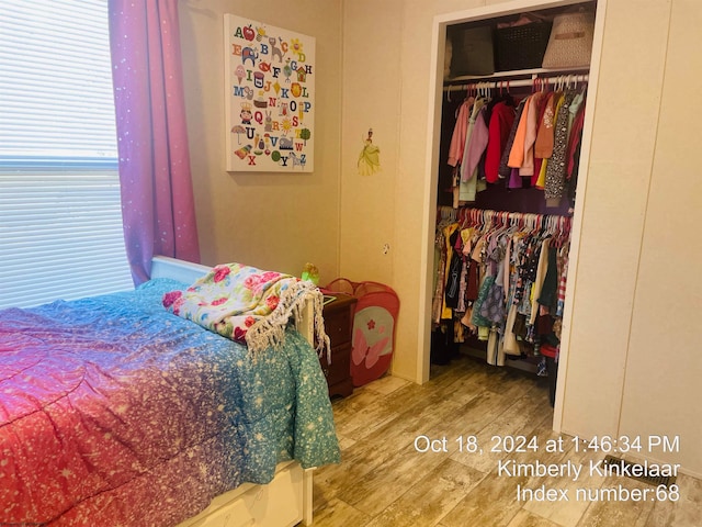 bedroom featuring hardwood / wood-style floors and a closet