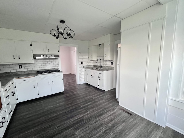 428 James St, Bridgeport, WV 26330 - kitchen with a notable chandelier, a sink, backsplash, under cabinet range hood, and dark wood-style floors