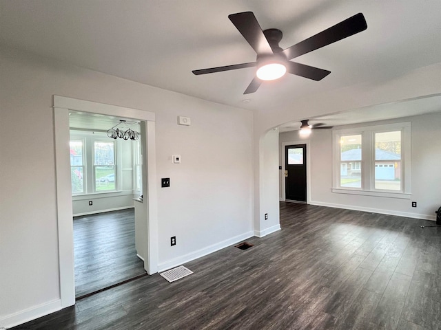 spare room with ceiling fan and dark wood-type flooring