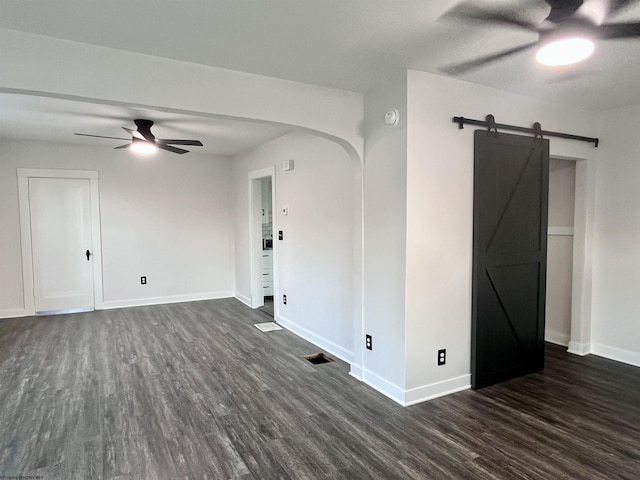 428 James St, Bridgeport, WV 26330 - empty room with a ceiling fan, dark wood finished floors, arched walkways, and a barn door