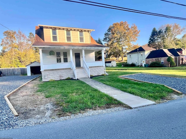 view of front facade featuring a front yard, a garage, and covered porch