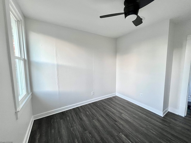 empty room featuring dark hardwood / wood-style flooring and ceiling fan