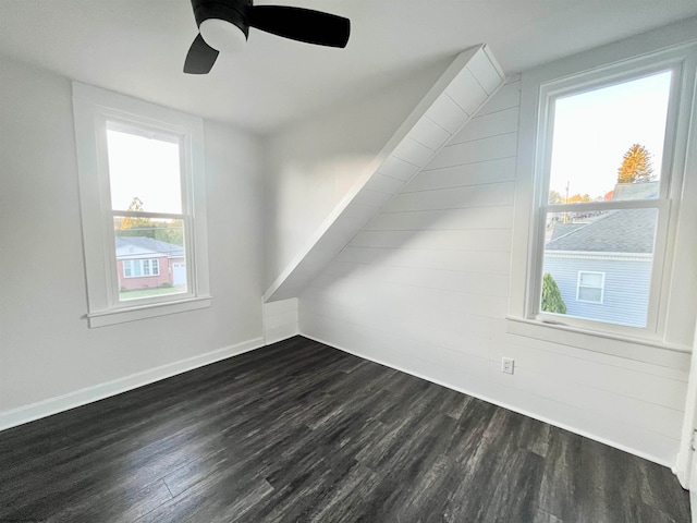 additional living space featuring ceiling fan, plenty of natural light, and dark hardwood / wood-style floors