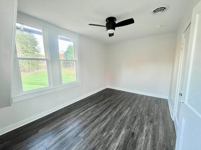 spare room with ceiling fan and dark hardwood / wood-style floors