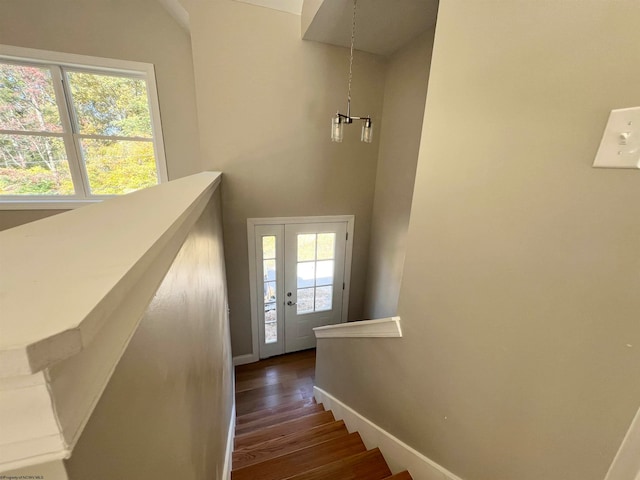 stairway featuring hardwood / wood-style flooring and plenty of natural light