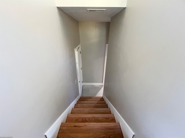 stairs with visible vents and baseboards