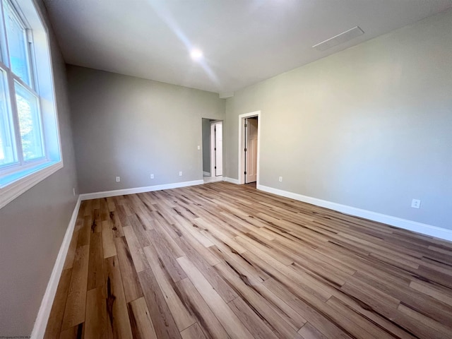 unfurnished room with baseboards and wood finished floors