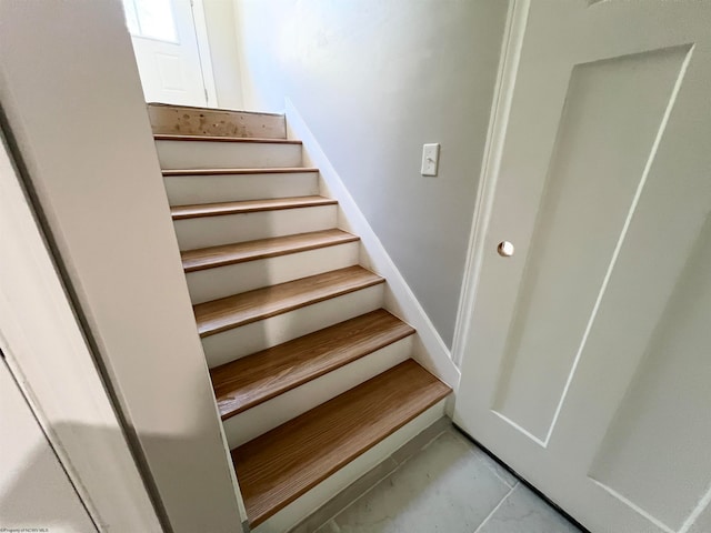 staircase with tile patterned floors