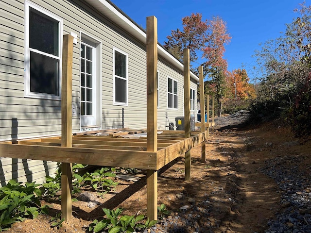 view of side of home with a wooden deck