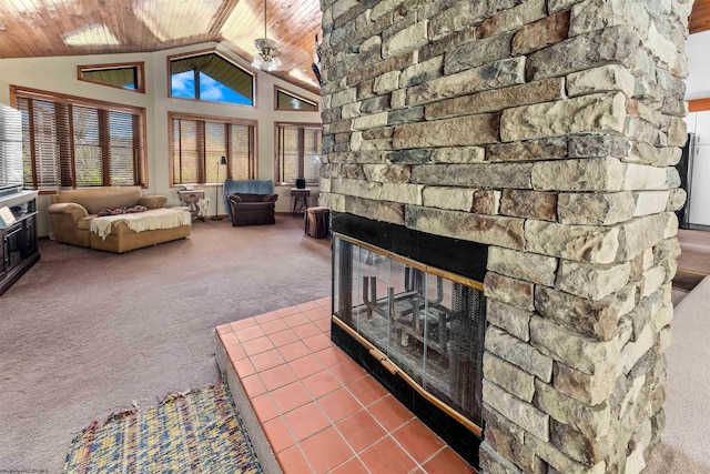 living room with wood ceiling, a healthy amount of sunlight, vaulted ceiling, carpet floors, and a stone fireplace