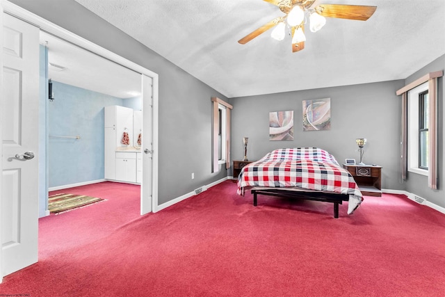 carpeted bedroom with a textured ceiling and ceiling fan