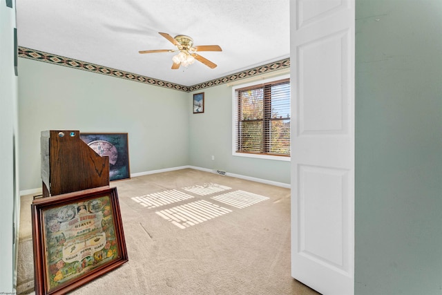 spare room featuring carpet flooring and ceiling fan