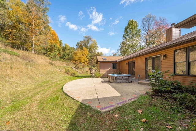 view of yard featuring a patio area and a hot tub