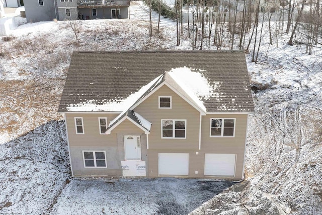 view of front of property featuring a shingled roof and an attached garage