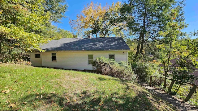 view of side of home featuring a yard