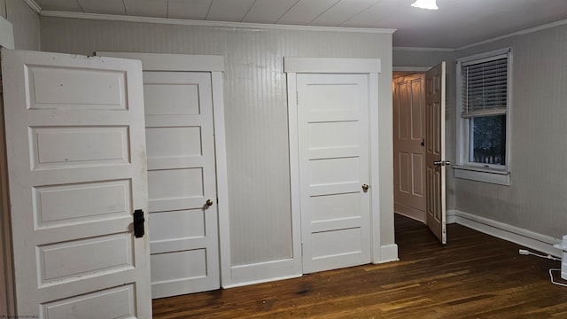 unfurnished bedroom featuring ornamental molding and dark hardwood / wood-style flooring