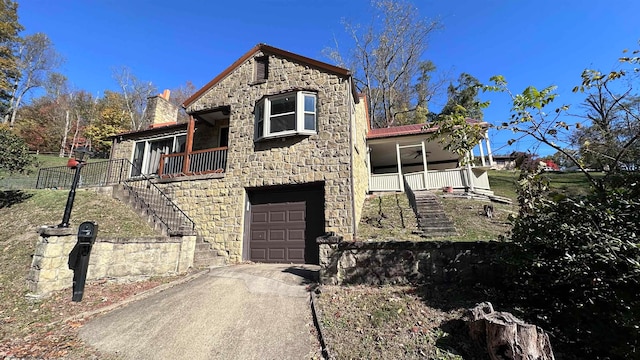 view of front of house featuring covered porch and a garage