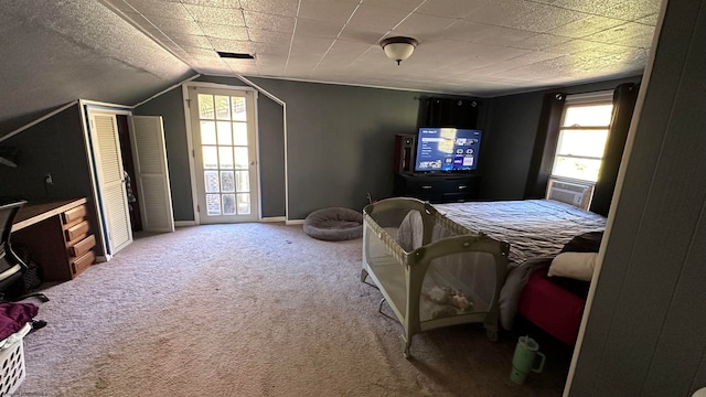 carpeted bedroom with vaulted ceiling and multiple windows