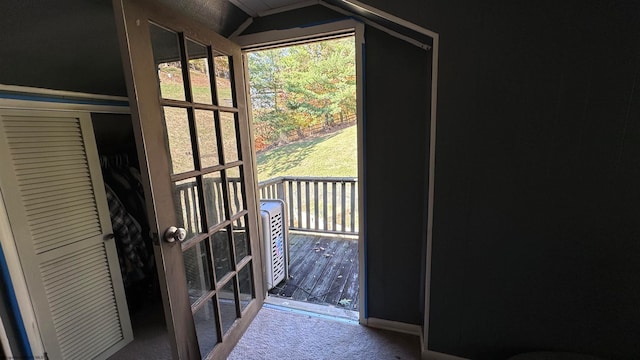 entryway with a wealth of natural light and carpet