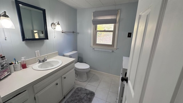 bathroom with vanity, toilet, and tile patterned floors