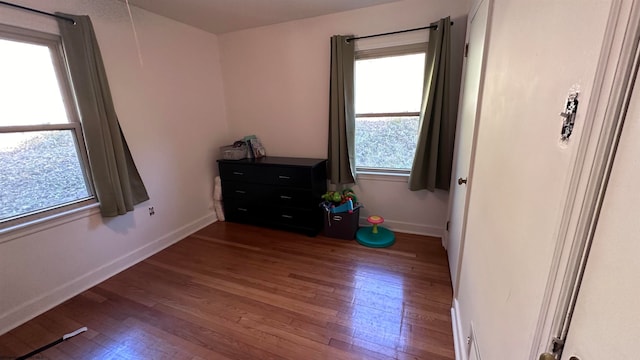 bedroom with dark hardwood / wood-style floors