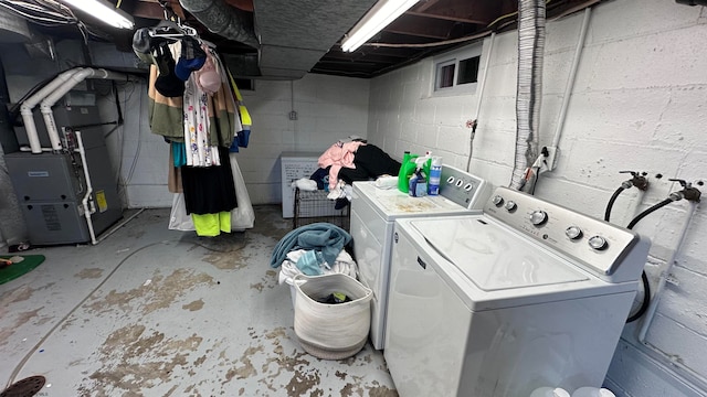 clothes washing area with washer and dryer and heating unit