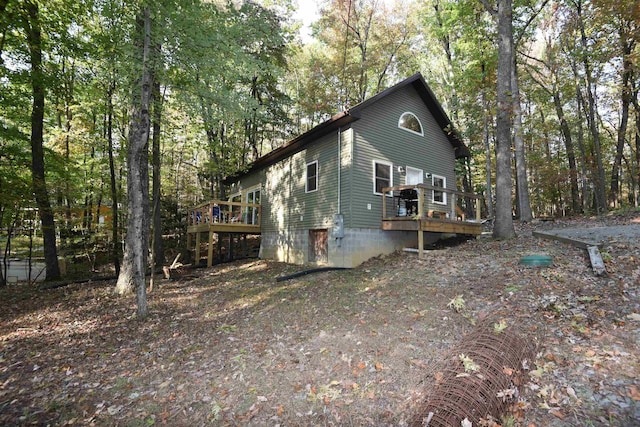 view of home's exterior with a wooden deck