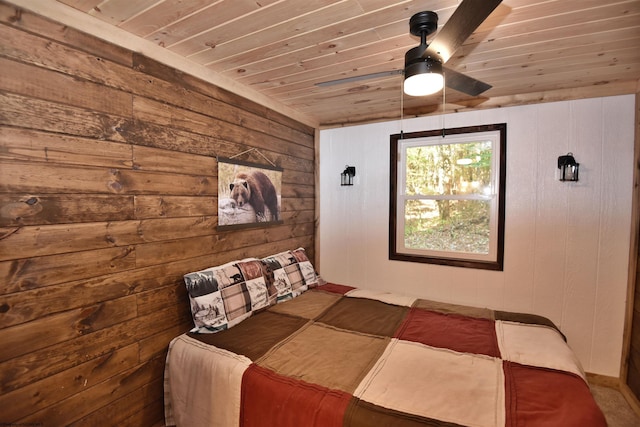 bedroom with ceiling fan, wood ceiling, and wooden walls