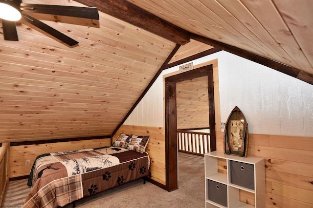 carpeted bedroom featuring ceiling fan, lofted ceiling with beams, wooden ceiling, and wooden walls