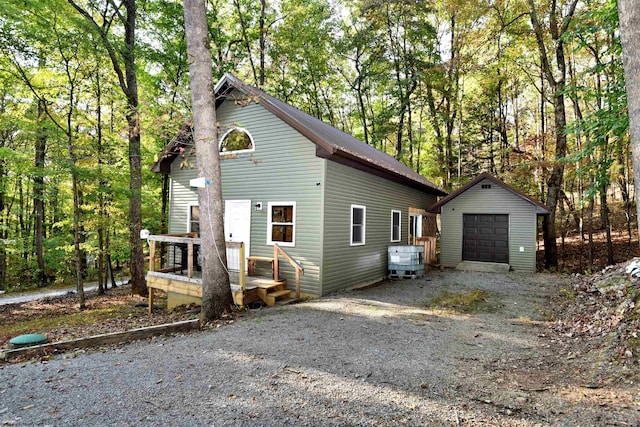 view of property with an outdoor structure and a garage