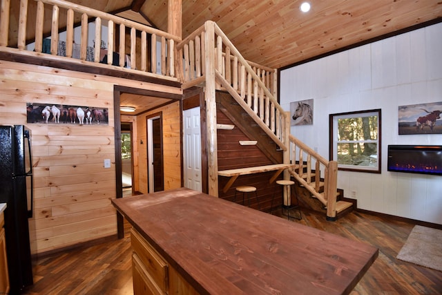 staircase with hardwood / wood-style floors, vaulted ceiling, wooden ceiling, and wooden walls