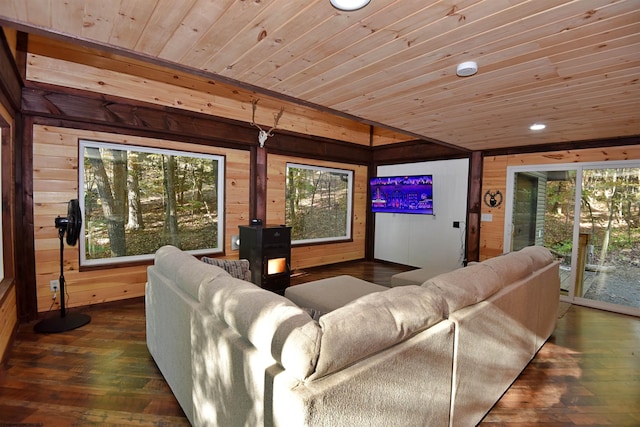 living room with dark hardwood / wood-style floors, wooden walls, and wooden ceiling