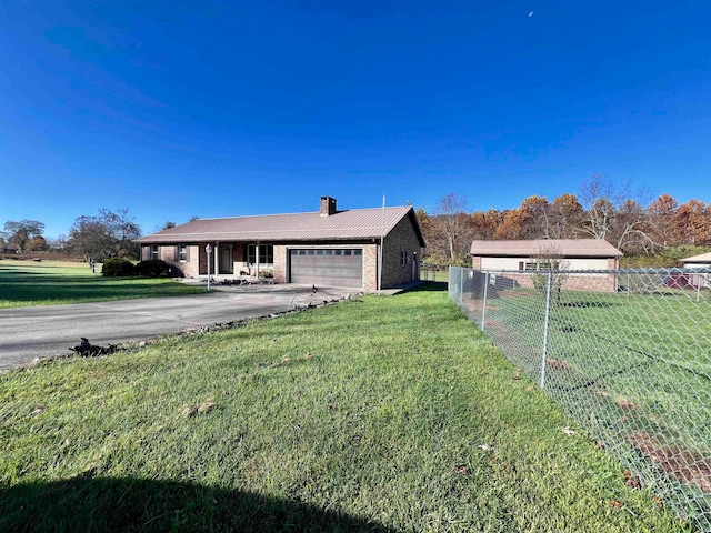 view of front facade with a front lawn and a garage