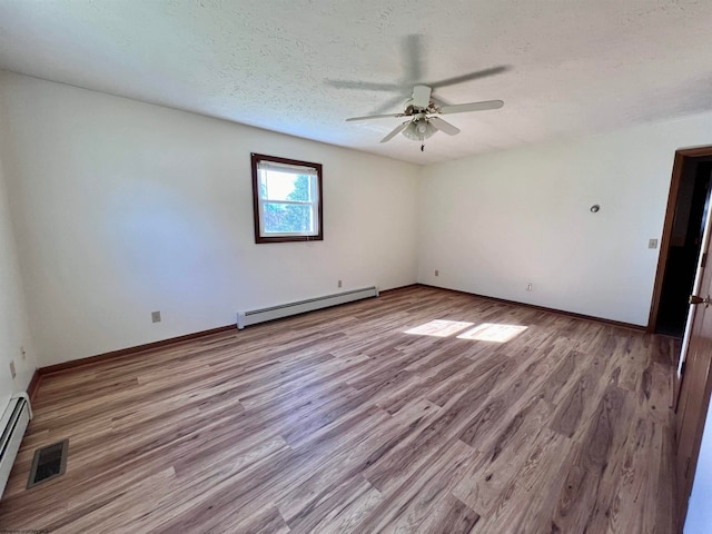 empty room featuring a baseboard heating unit, a textured ceiling, light hardwood / wood-style floors, and ceiling fan