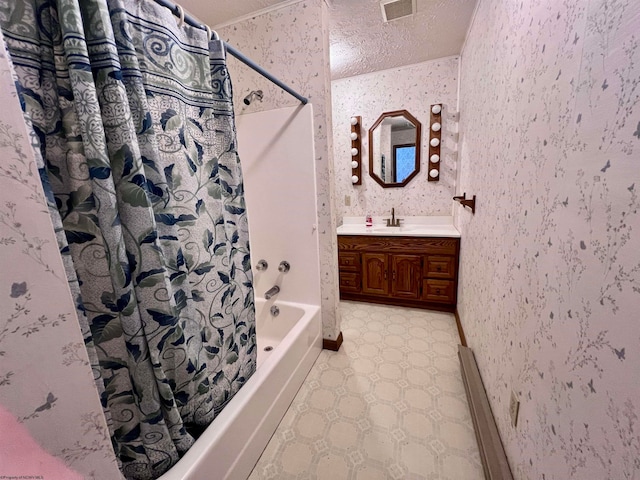 bathroom with vanity, shower / bath combo with shower curtain, and a textured ceiling