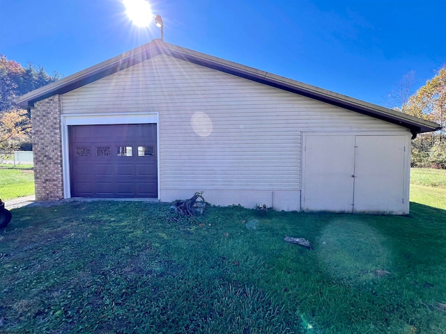 view of property exterior with an outbuilding, a garage, and a lawn