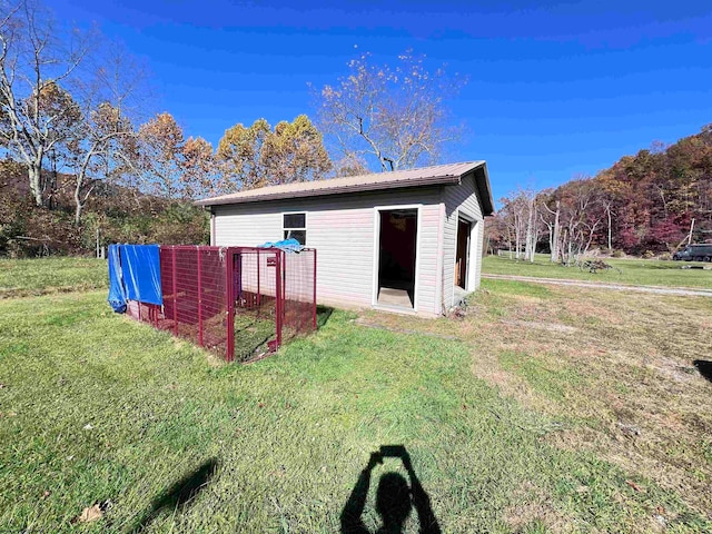 view of outbuilding with a yard