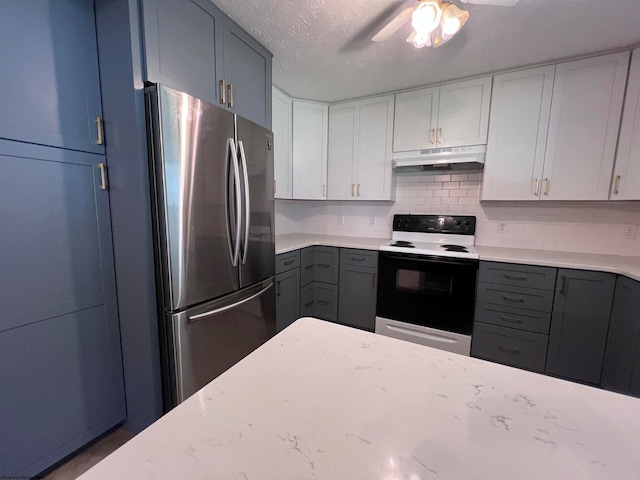 kitchen featuring tasteful backsplash, ceiling fan, a textured ceiling, stainless steel refrigerator, and white range with electric stovetop