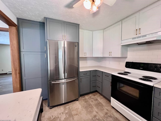 kitchen with a textured ceiling, white cabinetry, white electric range oven, stainless steel refrigerator, and gray cabinets