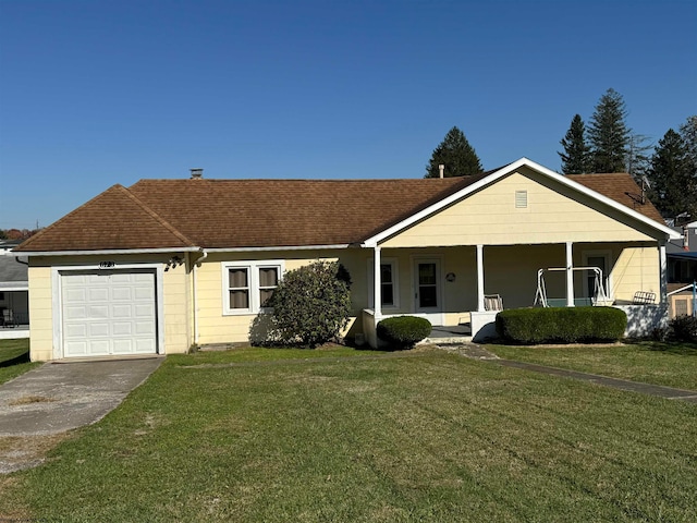 ranch-style house featuring covered porch, a garage, and a front lawn