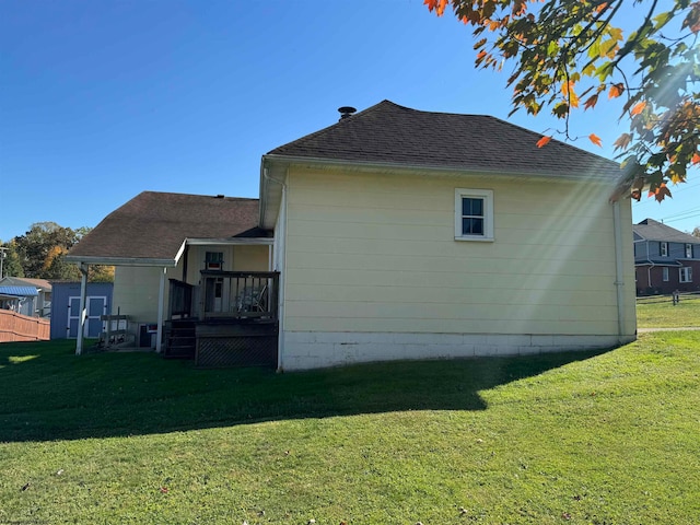 view of side of home with a lawn