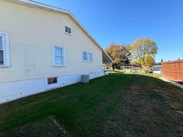 view of home's exterior with central AC and a lawn